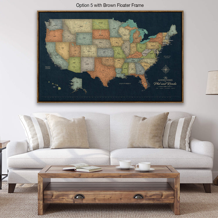 a large, detailed map of the United States displayed on a wall above a white sofa in a living room setting.