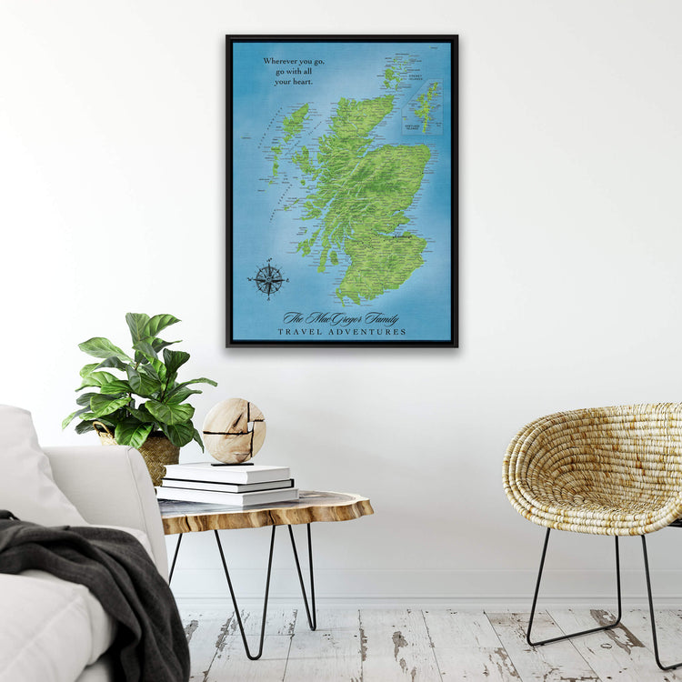 a framed map of Scotland hanging on a wall, with a quote about travel adventures below it.