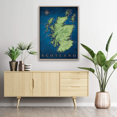 a framed map of Scotland hanging on a wall above a wooden cabinet or dresser. The cabinet has a light wood finish and has three drawers. The cabinet is positioned next to a potted plant, and there are two vases on the cabinet. The potted plant is placed on the floor, and the vases are on the cabinet.