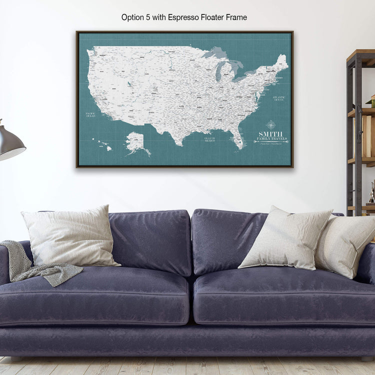 a large framed map of the United States with a dark blue couch and pillows in the foreground.