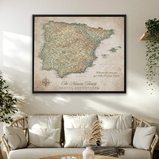 a large framed map of Spain hanging on a wall above a couch in a living room.