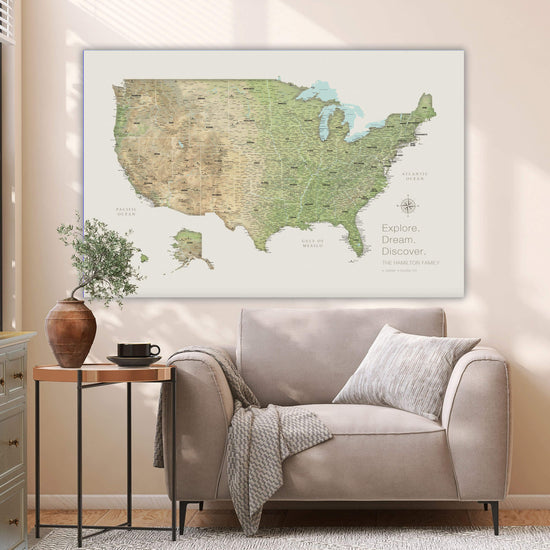 a large map of the United States hanging on a wall, with a cozy living room setting below it.