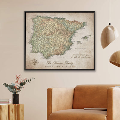a framed map of Spain hanging on a wall, with a quote about travel adventures below it.