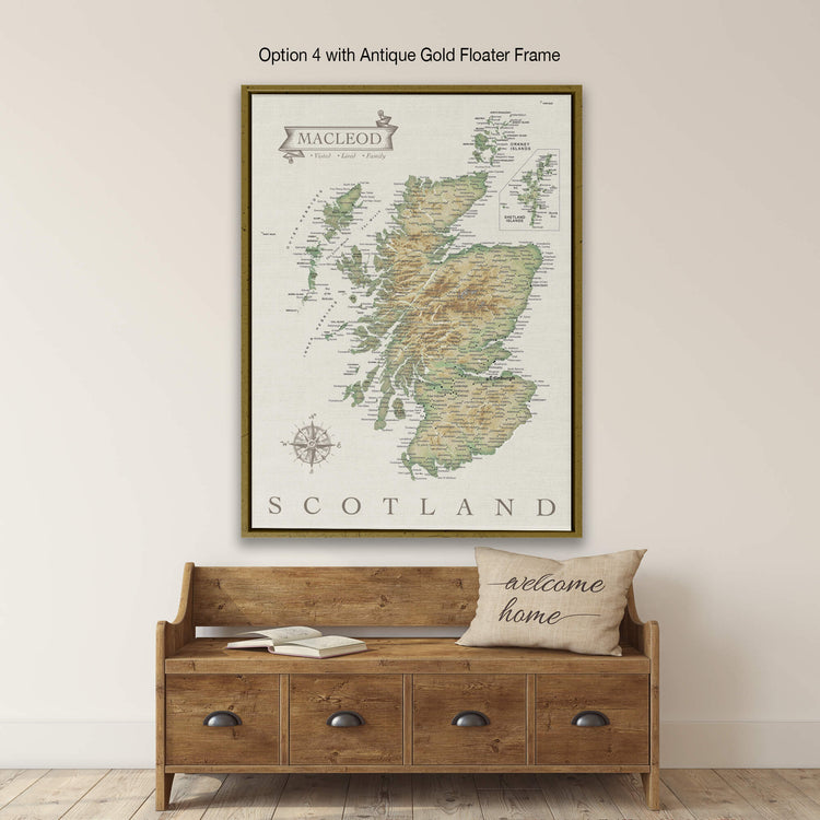 a large framed map of Scotland hanging on a wall above a wooden bench with a "welcome home" pillow on it.