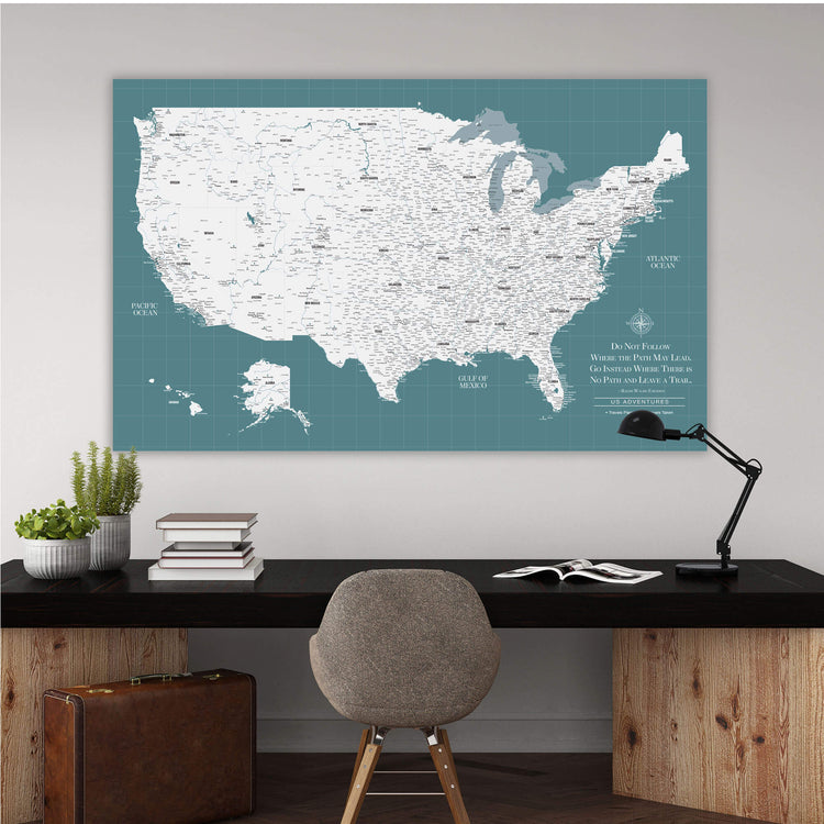 a large wall map of the United States, with a desk and chair in the foreground.