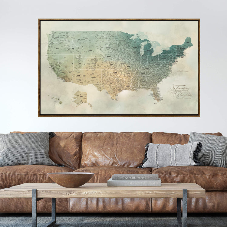 a large framed map of the United States hanging on a wall above a brown leather couch with a wooden coffee table in front of it.