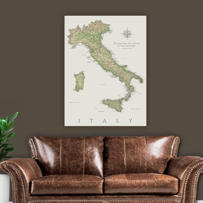 a large map of Italy hanging on a wall above a brown leather couch.