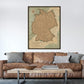 a large map of Germany hanging on a wall above a brown leather couch with pillows.