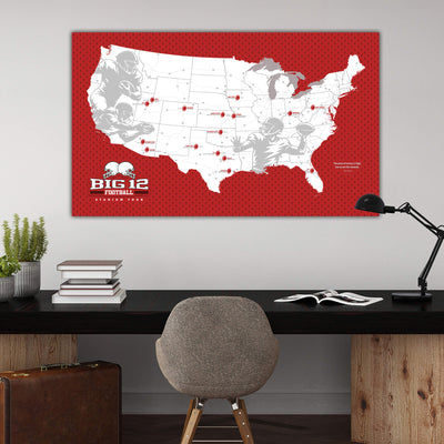 a large red map of the United States with various football teams and players marked on it, hanging on a wall above a wooden desk with a chair and a lamp.