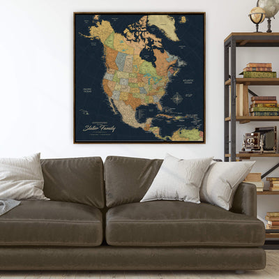 a large, detailed map of North America hanging on a wall above a brown leather couch.