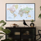 a large world map hanging on a wall, with a black bird figurine perched on a shelf below it.