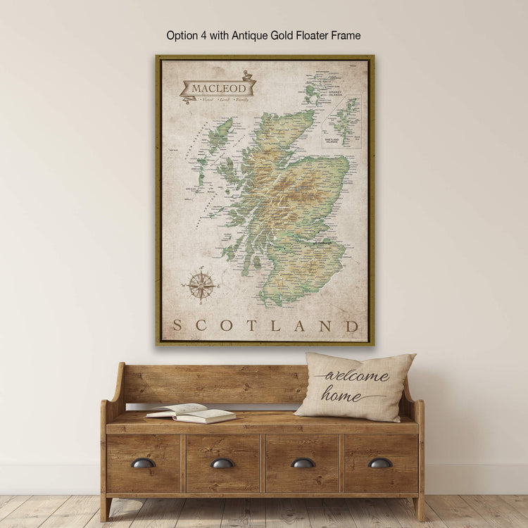 a large framed map of Scotland hanging on a wall above a wooden bench with a "welcome home" pillow on it.