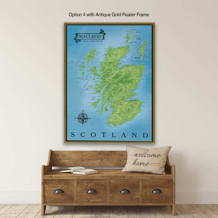 a large framed map of Scotland hanging on a wall above a wooden bench with a "welcome home" pillow on it.