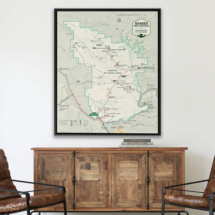 a large framed map of Hanging Meadows National Park hanging on a wall above a wooden cabinet.