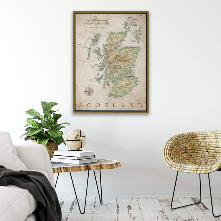 a framed map of Scotland hanging on a wall, with a cozy living room setting below it.