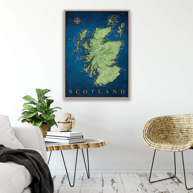 a framed map of Scotland hanging on a wall, with a cozy living room setting below it.