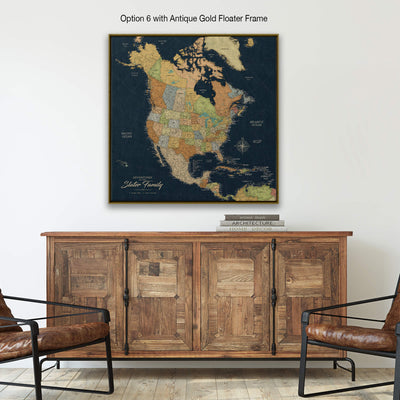 a large, antique gold-framed map of North America hanging on a wall above a wooden cabinet.