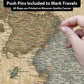 a person pointing at a map with pins on it
