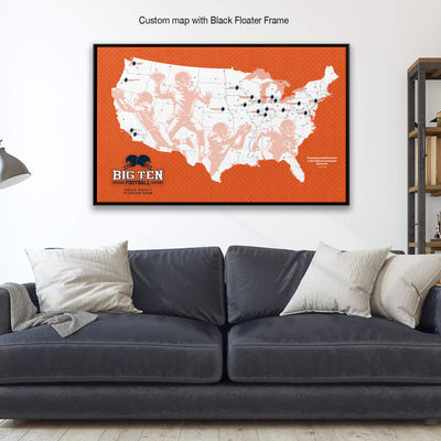 A custom map with a black floating frame is displayed on the wall above a gray couch with white pillows.