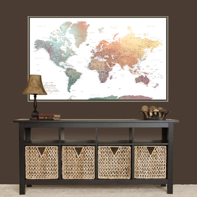a large world map displayed on a wall above a black console table with storage baskets below it.