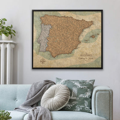 a large framed map of Spain hanging on a wall above a couch with decorative pillows.