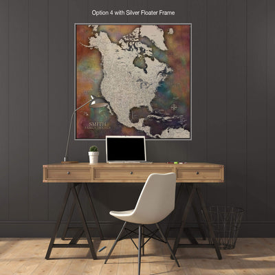 a large, colorful map of North America on the wall above a wooden desk with a laptop and a white chair.