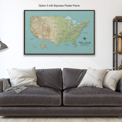 A large framed map of the United States is displayed on the wall above a gray couch with white pillows.