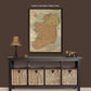 a table with baskets under a map on the wall