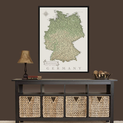 a large framed map of Germany hanging on a wall above a black console table with woven baskets below it.
