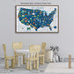 a large, colorful map of the United States with various landmarks and locations marked, displayed on a wall above a table with chairs.