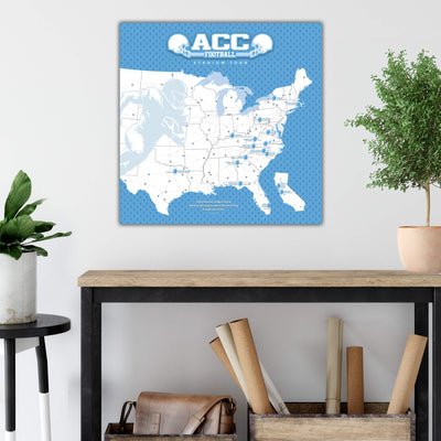 a wall-mounted map of the United States with football locations marked, along with a potted plant and some rolls of paper on a wooden shelf below it.