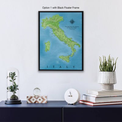 a framed map of Italy hanging on a wall, with a glass dome containing a plant, a white clock, and a stack of books below it.