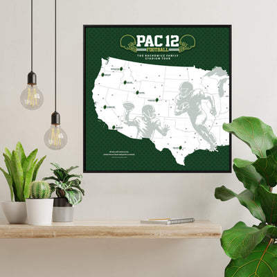 a framed map of the United States with football players depicted on it, hanging on a wall.