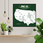a framed map of the United States with football players depicted on it, hanging on a wall.