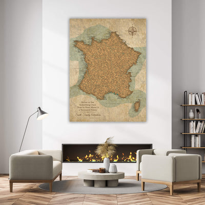 a living room with a large map of France hanging on the wall above a fireplace. The room has a cozy and inviting atmosphere, with a coffee table in the center and two chairs placed around it. There are also several books and decorative items in the room, creating a comfortable and personalized space.