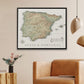 a framed map of Spain and Portugal hanging on a wall, with a brown leather armchair in the foreground.