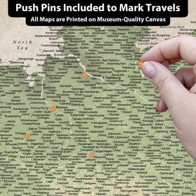 The image is a detailed map of various locations, with push pins indicating specific places. The map is printed on a canvas and includes all the locations marked on it.