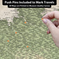 The image is a detailed map of various locations, with push pins indicating specific places. The map is printed on a canvas and includes all the locations marked on it.
