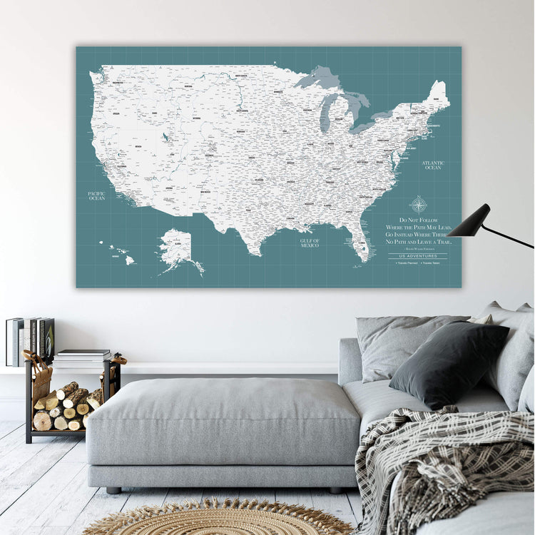 a large wall map of the United States, with a cozy living room setting in the foreground.