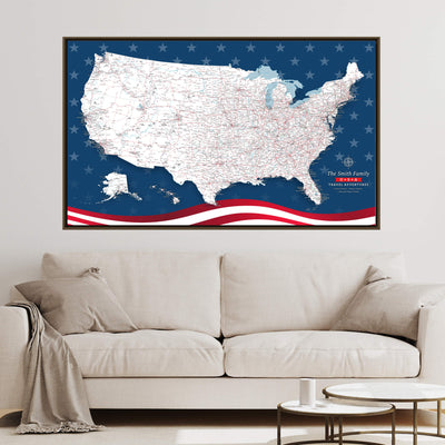 a large, detailed map of the United States with a blue background and red and white stripes, hanging on a wall above a white couch.