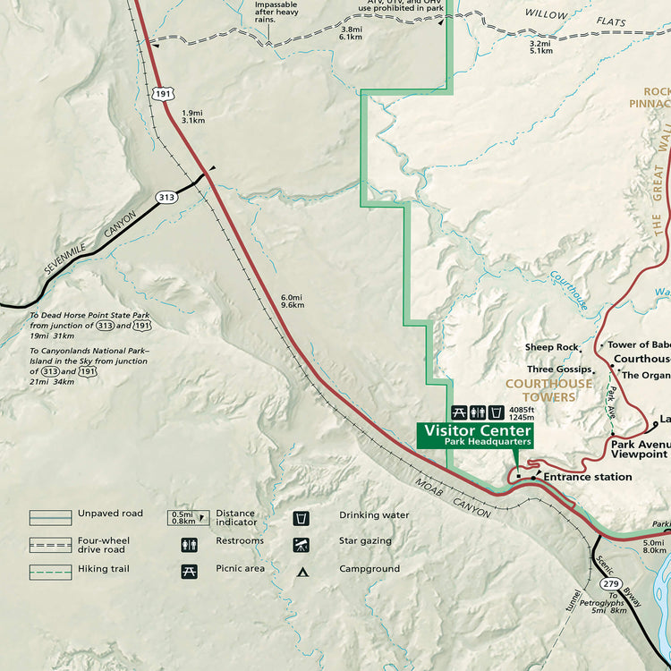 The image is a detailed map of a mountainous region, showing various landmarks, roads, and trails. It includes a visitor center, a parking area, and a trail for hiking. The map also provides distances and directions to different points of interest, such as the visitor center and the parking area. The image is not a collage of multiple images, but rather a single, comprehensive map that provides a clear and accurate representation of the area.