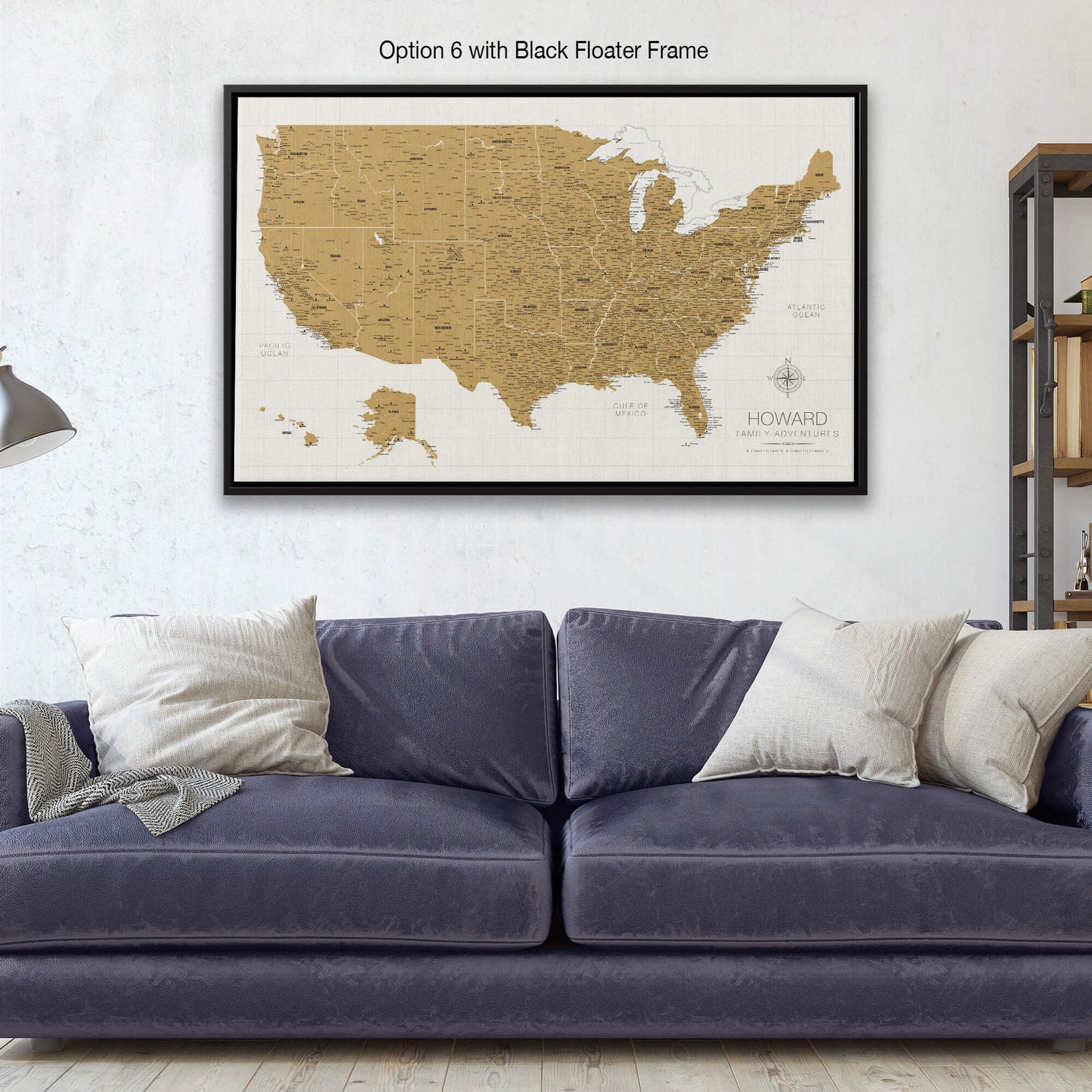 a living room with a blue couch and a map on the wall