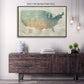 a large framed map of the United States hanging on a wall above a wooden cabinet or dresser. The cabinet has a dark finish and appears to be made of wood. There are also some decorative elements in the room, such as a potted plant and a vase.