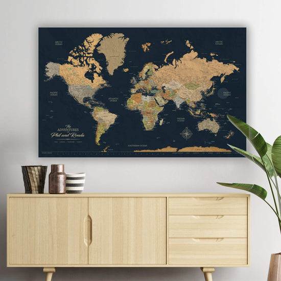 a large world map poster hanging on a wall above a wooden cabinet.