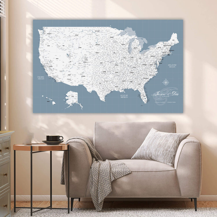 a large wall map of the United States, with a cozy living room setting with a sofa and a side table.