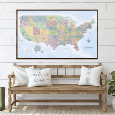 a large framed map of the United States with a wooden bench and pillows in front of it, creating a welcoming atmosphere.