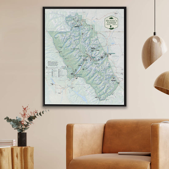 a large framed map of the Yellowstone National Park region hanging on a wall, with a brown leather couch in the foreground.