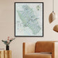 a large framed map of the Yellowstone National Park region hanging on a wall, with a brown leather couch in the foreground.