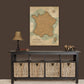 a wall-mounted map of France, a black console table with storage baskets, and a lamp on a shelf.