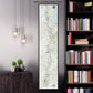 a wall-mounted map of South America, with a black floating frame. The map is surrounded by a variety of books on a bookshelf, creating a cozy and intellectual atmosphere.